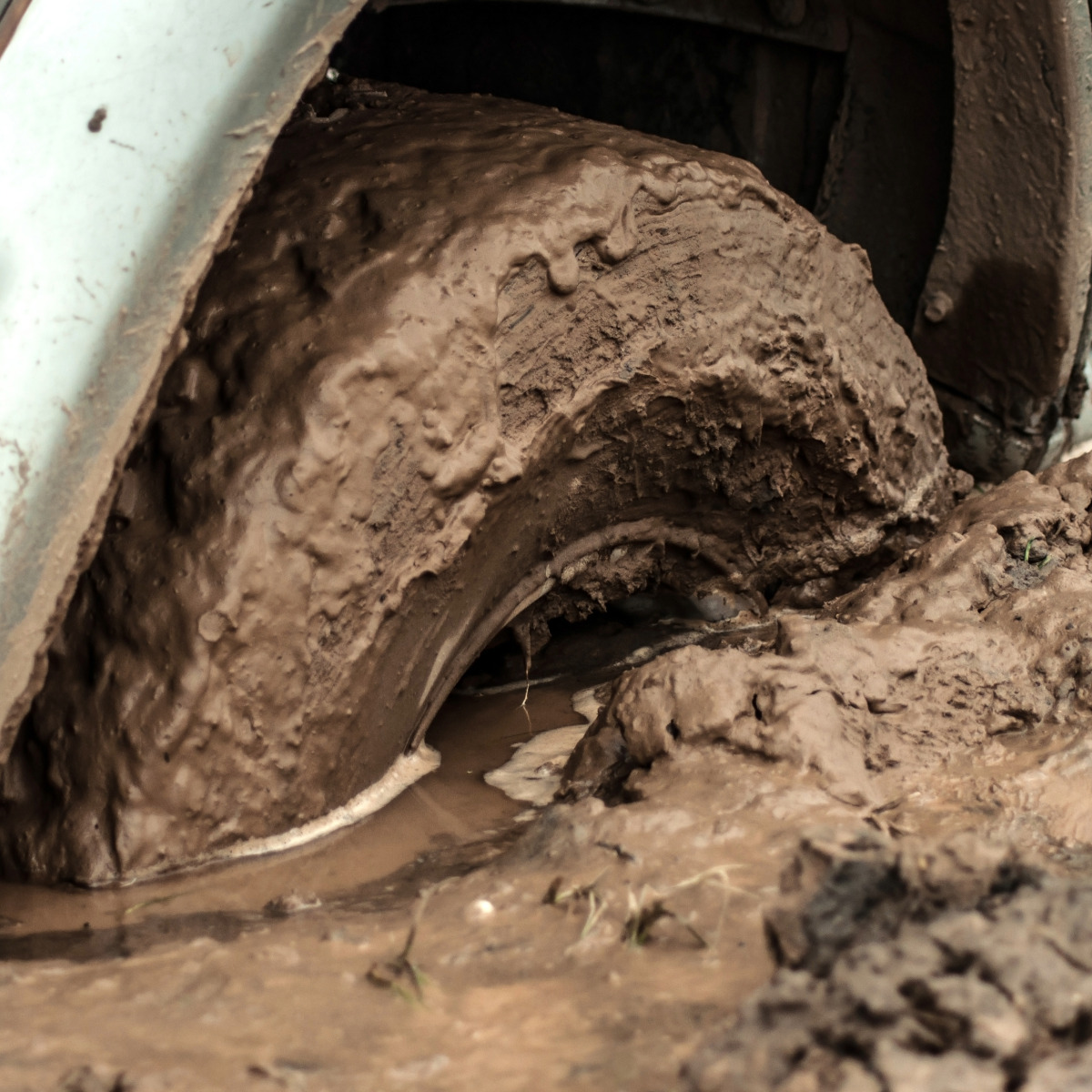 Winch out vehicle recovery service tire stuck in mud